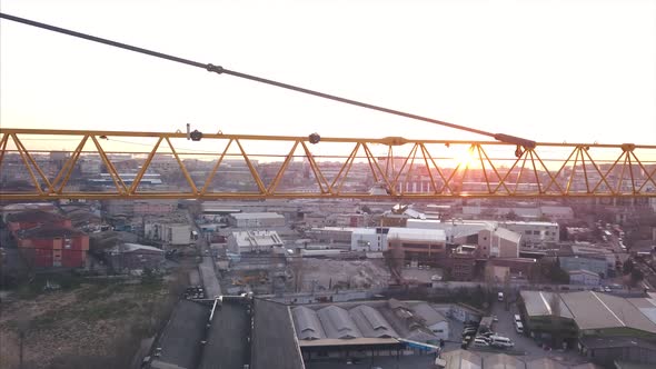 Aerial View Of Construction Crane With Sunrise Light Background