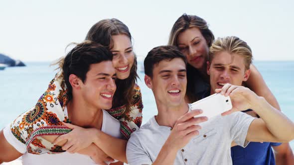 Friends taking selfie from mobile phone at beach