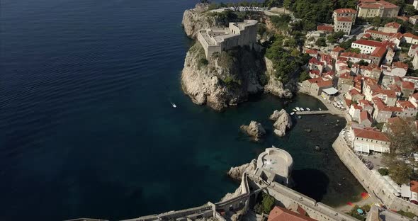 Aerial shot of Dubrovnik Old town, the camera rises slowly to reveal the ancient fort.