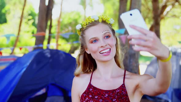 Woman making facial expression and taking selfie with mobile phone 4k