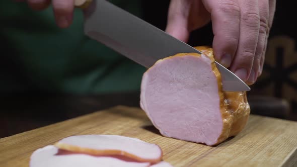 Close Up Video of Tasty Natural Ham Is Sliced By Sharp Knife on the Wooden Board, Jerky Smoked Meat