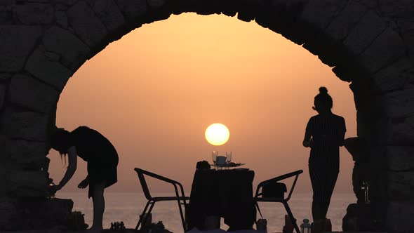 Preparing a romantic dinner at sunset