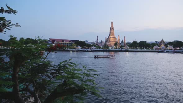 Bangkok at Night, Tourist Boat Water Taxi on River and Buddhist Temple of Wat Arun Cityscape and Cit