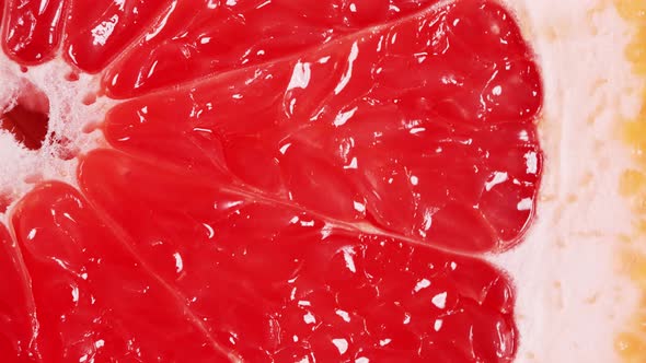 Slow Motion of Rotation Ripe Sliced Grapefruit