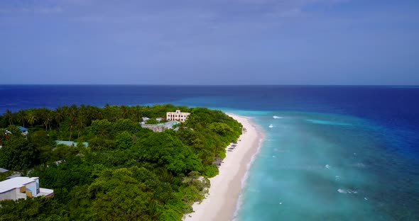 Wide overhead clean view of a white paradise beach and turquoise sea background in best quality 4K