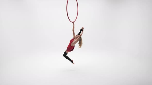 Young Beautiful Girl Doing Longitudinal Twine In The Aerial Ring