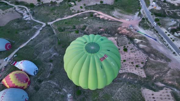 4K Aerial view of Goreme. Colorful hot air balloons fly over the valleys.