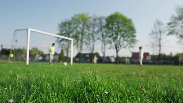 Kids Playing Soccer on the Grass