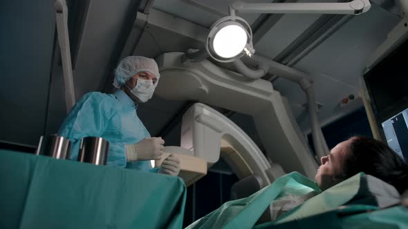 Male Surgeon Advises Female Patient in Operating Room