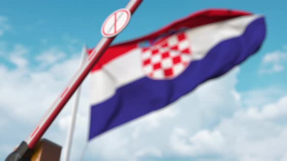 Closing Barrier with STOP CORONAVIRUS Sign at the Croatian Flag