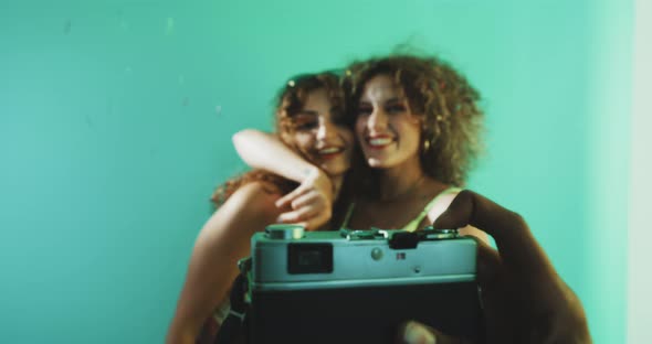 Party curly girls posing for pictures