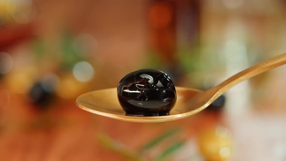 Olive Oil Black Oilve on Brown Background Closeup
