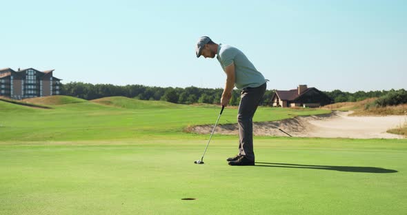 Concentrated Golf Player Hitting Ball To Hole, Playing Golf Outdoor at Course