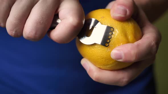 Woman removes lemon peel super slow motion