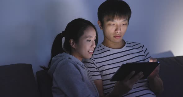 Asian couple use of tablet computer at home