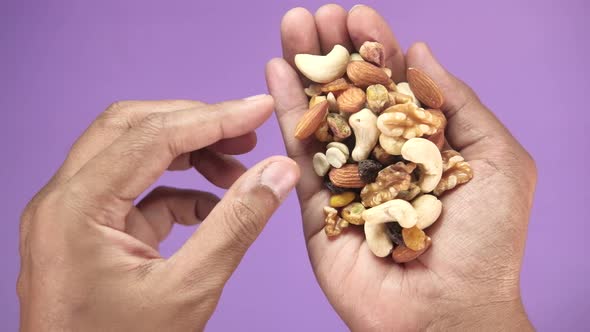 Close Up of Man Hand's Eating Mixed Nut 