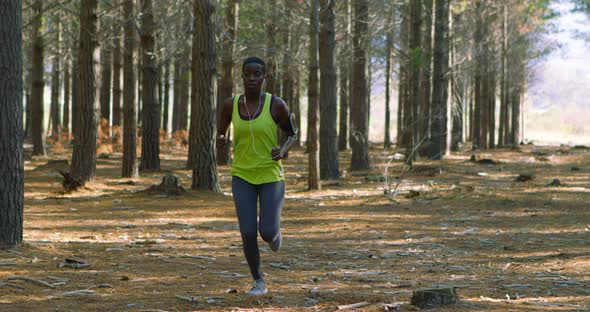 Female jogger running in the forest 