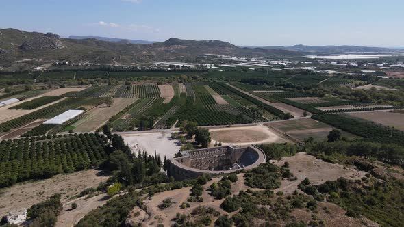 View of the Ancient Theater Across Green Farmland