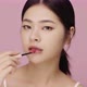 Close up face of beautiful young Asian woman applying lip on her lips on pink background. - VideoHive Item for Sale