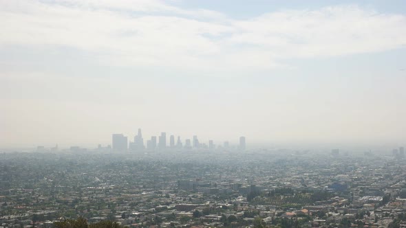 pan of the downtown Los Angeles skyline bathed in smog