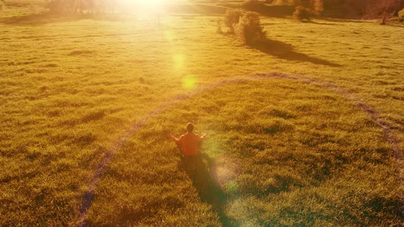 Low Altitude Radial Flight Over Sport Yoga Man at Perfect Green Grass