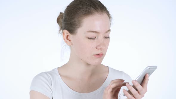 Young Redhead Woman Using Smartphone, Texting Message