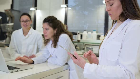 Group of scientists discussing research details in lab