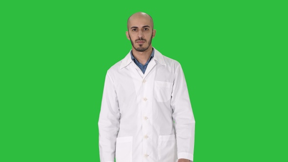 Walking male arab doctor on a Green Screen, Chroma Key.