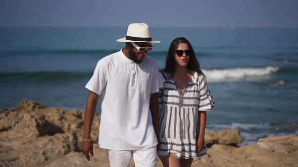 Portrait of Happy Millennial Interracial Couple Talking Walking in Slow Motion on Mediterranean