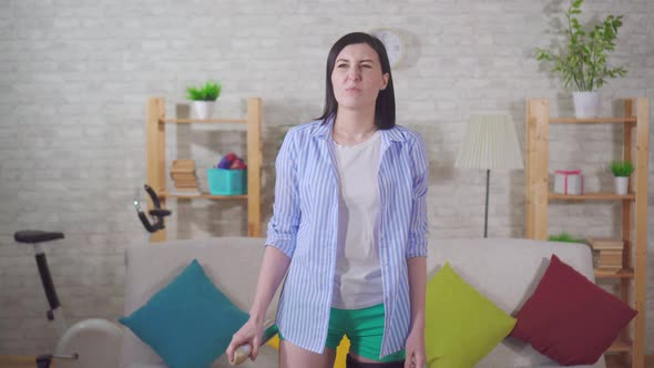 Disappointed Woman Housewife Uses a Spray Freshener for the Air