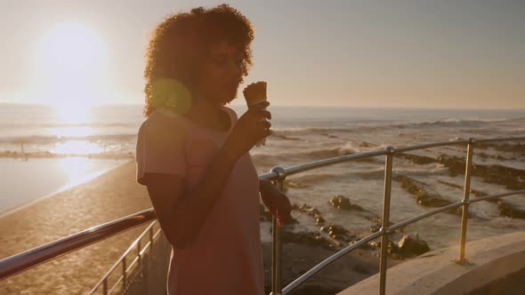 Woman eating ice cream at sunset