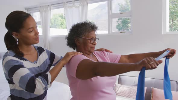 Senior mixed race woman exercising at home. Social distancing and self isolation in quarantine