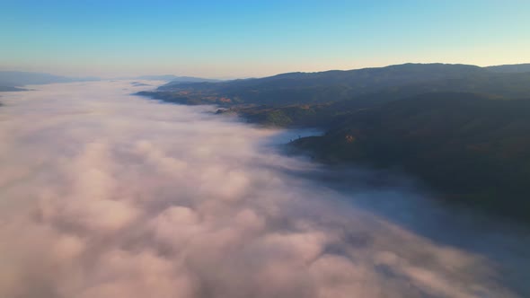 4K Aerial Flying Above Sea of Fog at Sunrise