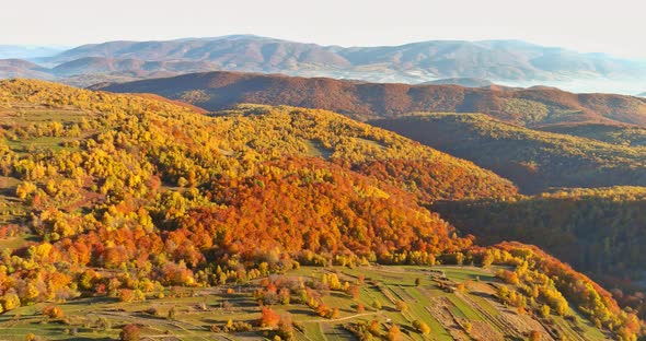 A View From a Height of a Yellow Forest Mountain Valley Surrounded By High Mountains