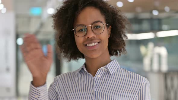 Cheerful African Businesswoman Waving at the Camera 