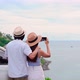 Young couple traveler looking at the beautiful sea view with their car while traveling - VideoHive Item for Sale