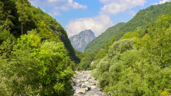 Timelapse of Mongioie peak in Nava and the river Tanaro leading to the mountain in Ormea valley.  Su