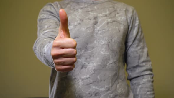 Man in Gray Show Gesture Thumbs Up