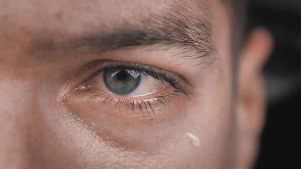 Closeup Shot of Crying Man with Tears in Eye