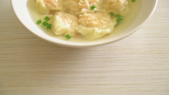 shrimp dumpling soup in white bowl - Asian food style