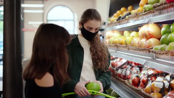Two Girls Choosing Bio Food Produces in Fruits Supermarket