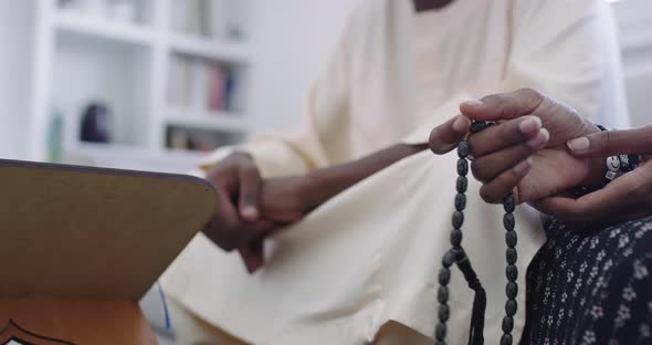 African Muslim Couple at Home in Ramadan Reading Quran Holly Islam Book