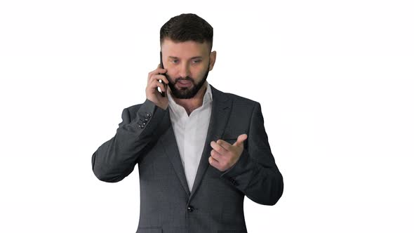 Business Man with a Beard Making a Serious Call on White Background