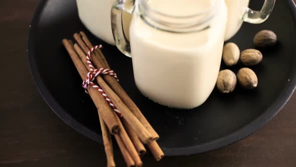 Traditional holiday drink egg nog in drinking mason jars.