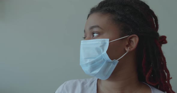 Close Up Portrait of Young African Woman in Medical Mask