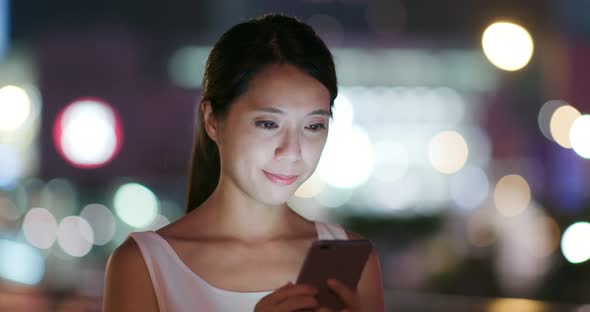 Woman use of cellphone at night