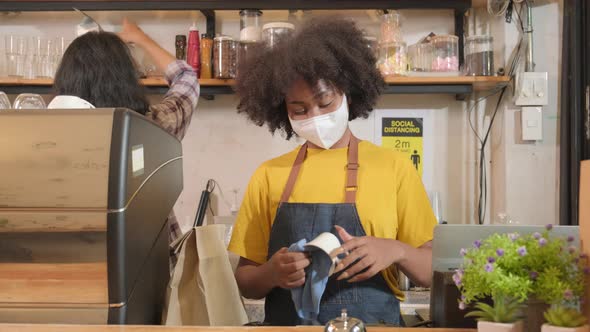 Female barista waiting for customers in cafe, SME business impact from COVID19.