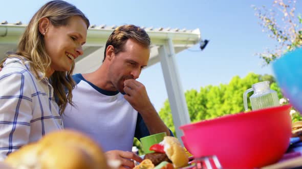 Couple interacting while having meal in garden house