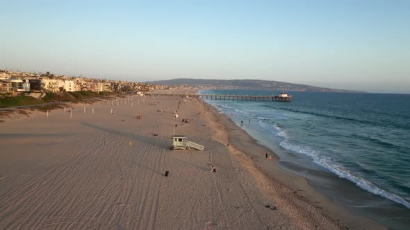 Beachgoers Relaxing At Manhattan Beach Pier At Dusk In California, USA. - aerial