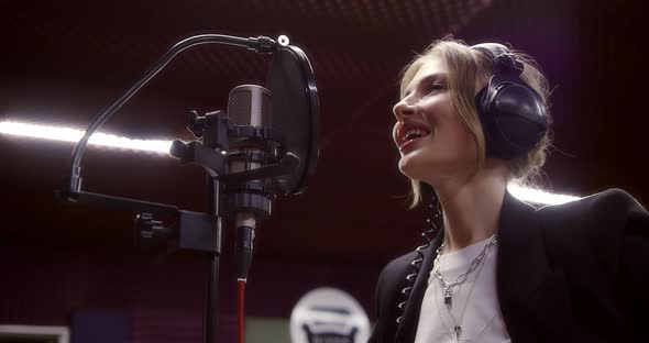 Positive Woman Talking to a Music Producer in a Recording Studio